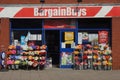 Store entrance displaying colorful bunches of flowers in the sunshine.